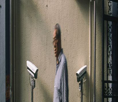 September 23, 2019, Shanghai, China - An elderly man ewalks past four newly installed security cameras in a laneway in Xuhui District. China has around 200 million surveillance cameras. (Dave Tacon/Polaris) ///