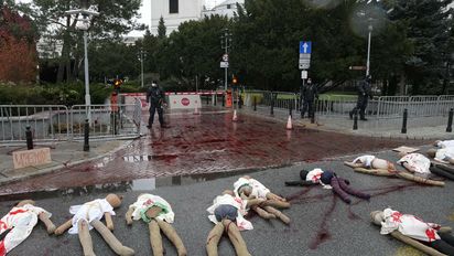 A view of dummies in a street to signify women who are suffering because of Poland's restrictive abortion law and a proposal for further restrictions, during a demonstration in front of parliament, in Warsaw, Poland, Tuesday, Nov. 30, 2021. Women’s rights activists used red paint symbolizing blood to protest a government plan to register every pregnancy in a national database and a proposal to further restrict abortion. The activists fear the database will allow authorities to track whether pregnancies end in a birth. Poland last year restricted its already conservative abortion law and abortions are now only allowed in cases of rape or incest, of if the woman’s life or health is in danger. (AP Photo/Czarek Sokolowski)