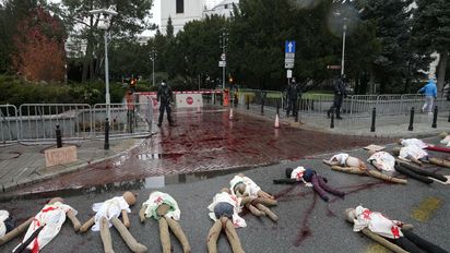 A view of dummies in a street to signify women who are suffering because of Poland's restrictive abortion law and a proposal for further restrictions, during a demonstration in front of parliament, in Warsaw, Poland, Tuesday, Nov. 30, 2021. Women’s rights activists used red paint symbolizing blood to protest a government plan to register every pregnancy in a national database and a proposal to further restrict abortion. The activists fear the database will allow authorities to track whether pregnancies end in a birth. Poland last year restricted its already conservative abortion law and abortions are now only allowed in cases of rape or incest, of if the woman’s life or health is in danger. (AP Photo/Czarek Sokolowski)