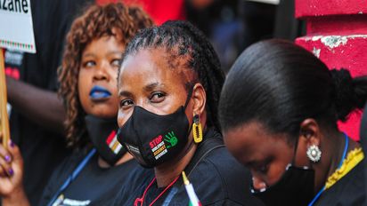 DURBAN, SOUTH AFRICA - APRIL 26: Marchers at the China Mall, formally the Wheel Shopping Centre during the Gender-Based Violence (GBV) protest march organised by the Office of The Premier in collaboration with Phepha Foundation on April 26, 2021 in April 26, 2021 in Durban, South Africa. According to a media release,  the march was triggered by high-profile cases which were reported to the KZN Provincial Gender-Based Committee where three women, who were employed as cleaners in the China Mall shopping Centre, were allegedly sexually assaulted at work by their manager and supervisor. (Photo by Darren Stewart/Gallo Images via Getty Images)