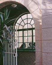 "People on the Move erhalten Sprachunterricht hinter einem vergitterten Fenster"