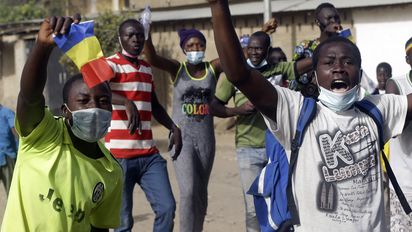 People protest in N'Djamena, Chad, Tuesday, April 27, 2021. Thousands of people protested and two people were killed in Chad Tuesday in demonstrations against the rule of a transitional military council headed by the son of the late President Idriss Deby Itno, who was killed last week. (AP Photo/Sunday Alamba)