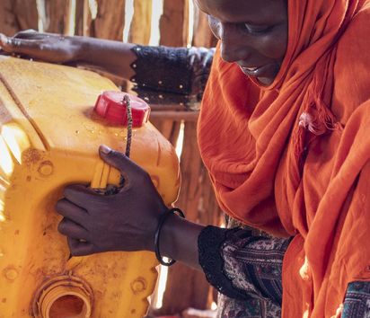 Fatuma Abdullhai (35) boils water for tea at her home in Tarama in north-eastern Kenya.