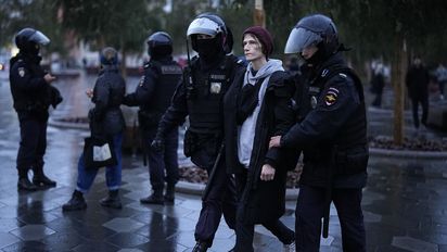 Police officers detain a demonstrator during a protest against a partial mobilization in Moscow, Russia, Saturday, Sept. 24, 2022. (AP Photo)