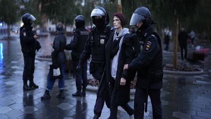 Police officers detain a demonstrator during a protest against a partial mobilization in Moscow, Russia, Saturday, Sept. 24, 2022. (AP Photo)