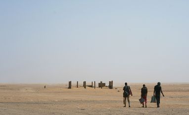 FILE - In this Sunday, June 3, 2018 file photo, three men head north towards Algeria after crossing the Assamaka border post in northern Niger. More than 80 African migrants were rescued on Thursday, Sept. 3, 2020 after being found in a remote stretch of the Sahara Desert where hundreds of others have died along the perilous journey in recent years, the International Organization for Migration said Tuesday, Sept. 8, 2020. (AP Photo/Jerome Delay, File)