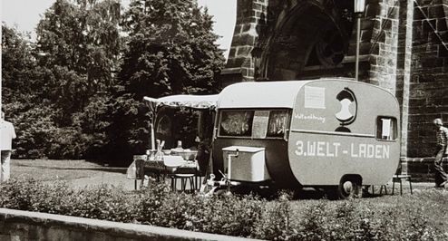 Schwarz-Weiß Foto von einem Wohnwagen mit der Aufschrift "3. Welt-Laden"