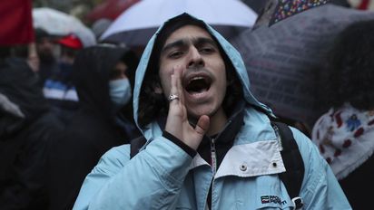 An anti-government protester chants slogans during a demonstration to denounce the country's deteriorating economic and financial conditions, in front of the Central Bank in Beirut, Lebanon, Sunday, Jan. 23, 2022. (AP Photo/Bilal Hussein)