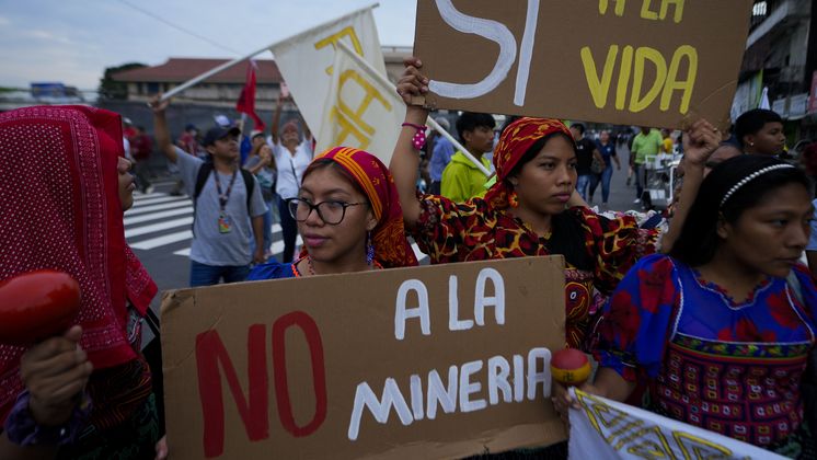 Gunas Indigenous women hold up signs tha read in Spanish "No to mining" and "Yes to life," during a march outside the National Assembly to protest against a mining contract between First Quantum Minerals of Canada and Panama's government over the Cobre Panama copper mine, in Panama City, Thursday, Oct. 19, 2023. (AP Photo/Arnulfo Franco)