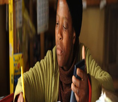 A customer of a neighbourhood shop of the Africa Cooperative Action Trust in Kaphunga / Swaziland. Life in the mountainous region has become much easier since then, as everyday necessities can now be bought close to home. (Photo: Christof Krackhard) A customer of a neighbourhood shop of the Africa Cooperative Action Trust in Kaphunga in the neighbourhood shop..