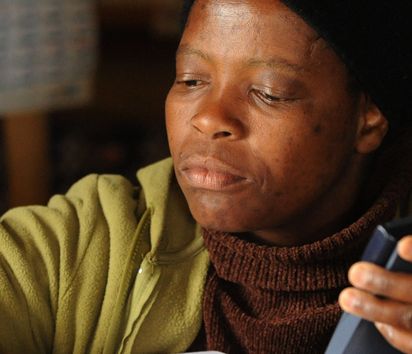 A customer of a neighbourhood shop of the Africa Cooperative Action Trust in Kaphunga in the neighbourhood shop..
